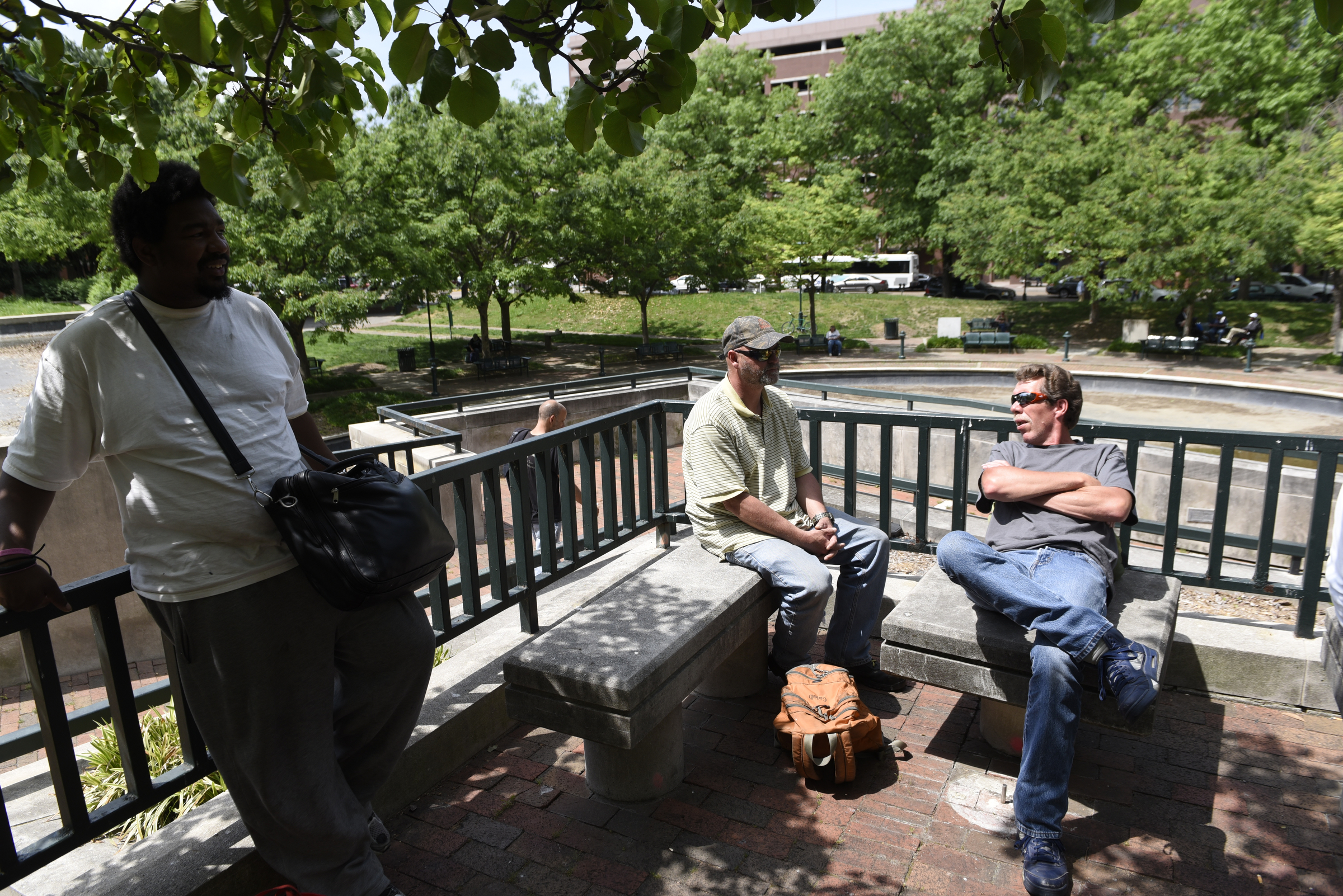 Antoine Ray, Roy Steinbach and Rick Barker, from left, wait on a meal at Miller Park on Wednesday, Apr. 27, 2016, in Chattanooga, Tenn.
