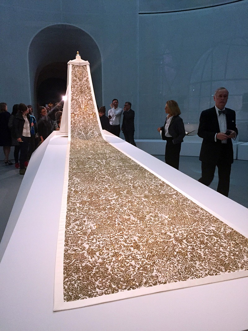 
              A wedding gown train by Karl Lagerfeld for Chanel's 2015 Patrimoine Collection is displayed as part of the "Manus x Machina: Fashion in the Age of Technology," exhibit at the Metropolitan Museum of Art in New York on Monday, May 2, 2016. The exhibit opens May 5 and runs through Aug. 14. (AP Photo/Jocelyn Noveck)
            