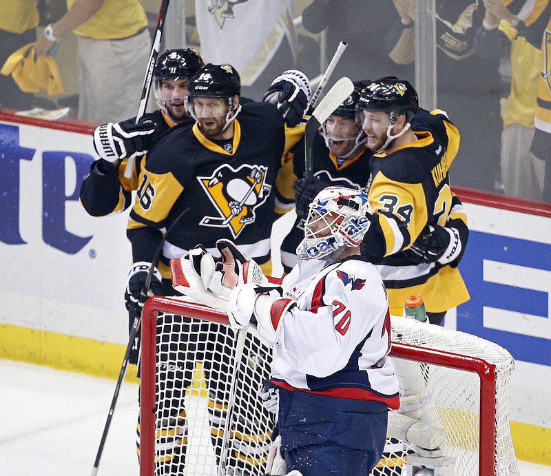 
              Pittsburgh Penguins Tom Kuhnhackl (34) celebrates his goal with his teammates behind Washington Capitals goalie Braden Holtby (70) during the first period of Game 3 in an NHL hockey Stanley Cup Eastern Conference semifinals in Pittsburgh, Monday, May 2, 2016. (AP Photo/Gene J. Puskar)
            