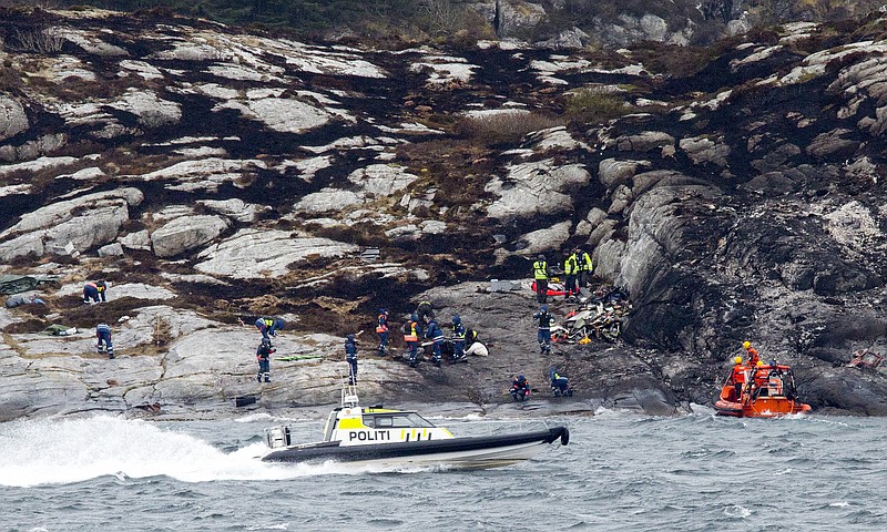 
              Police and rescue workers investigate at the scene following the Friday April 29 helicopter crash on the coast of Norway near Bergen, Sunday May 1, 2016.  Emergency crews salvaged the wrecked fuselage of the Airbus helicopter from the sea Saturday, along with the flight recorders, and retrieved the rotor blades following the crash which killed the 13 people on board. (Torstein Boe / NTB Scanpix via AP) NORWAY OUT
            