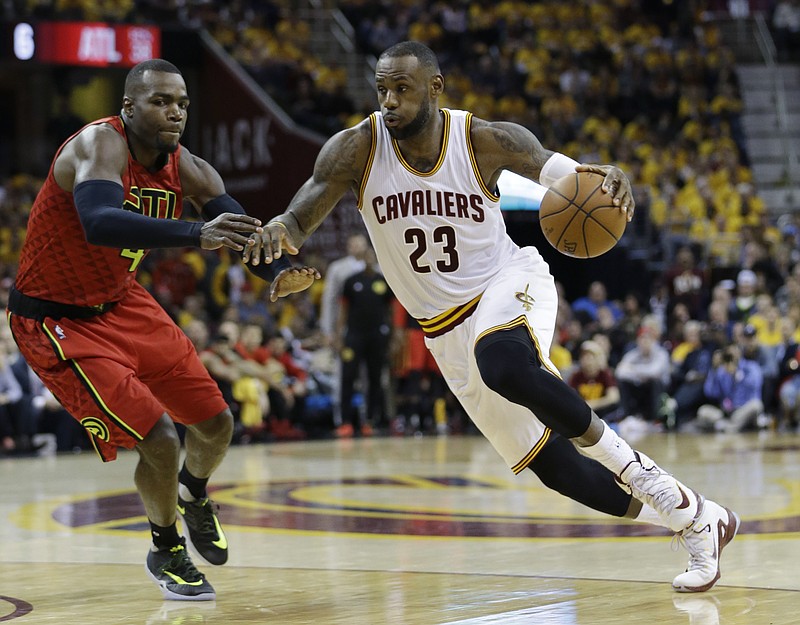 Cleveland Cavaliers' LeBron James (23) drives on Atlanta Hawks' Paul Millsap (4) in the second half in Game 1 of a second-round NBA basketball playoff series Monday, May 2, 2016, in Cleveland.