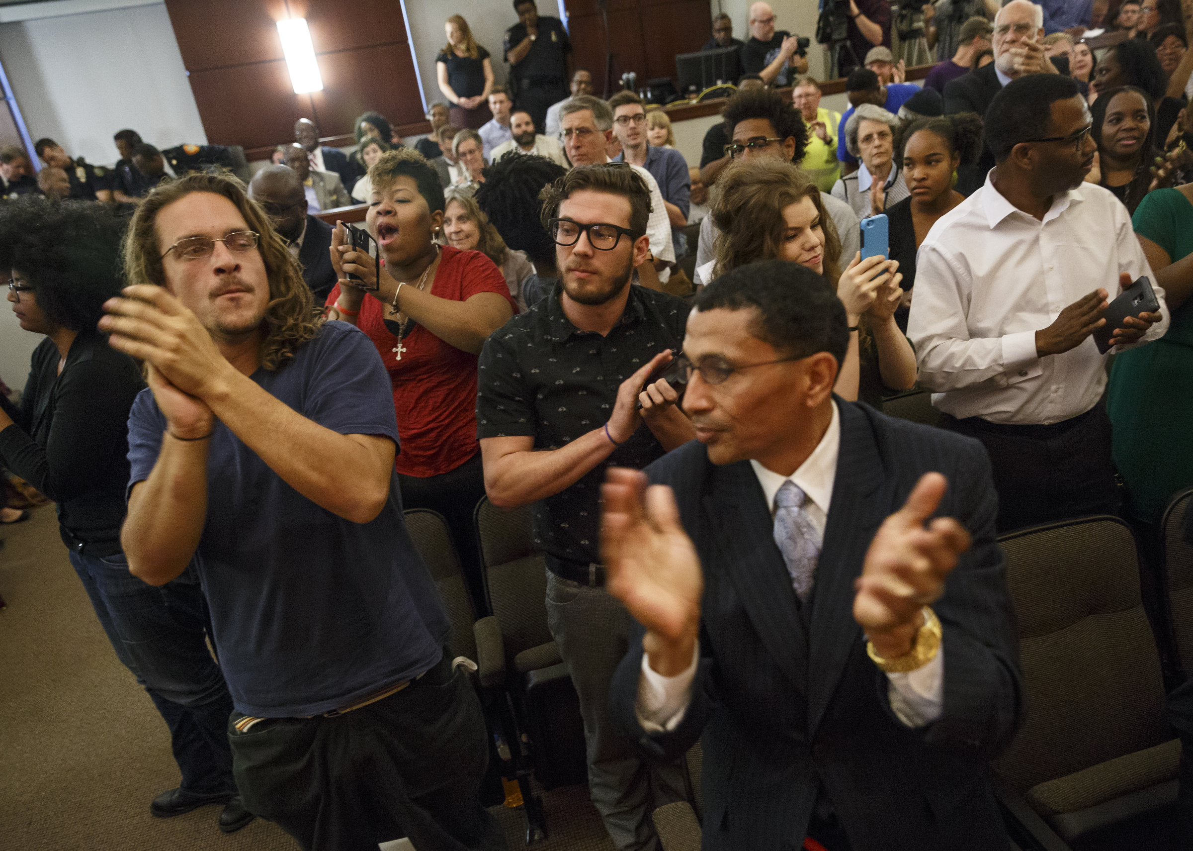 Community members applaud Kevin Muhammad as he speaks during a Chattanooga City Council Meeting on Tuesday, May 3, 2016, in Chattanooga, Tenn. Muhammad, with the Nation of Islam, delivered what he called a