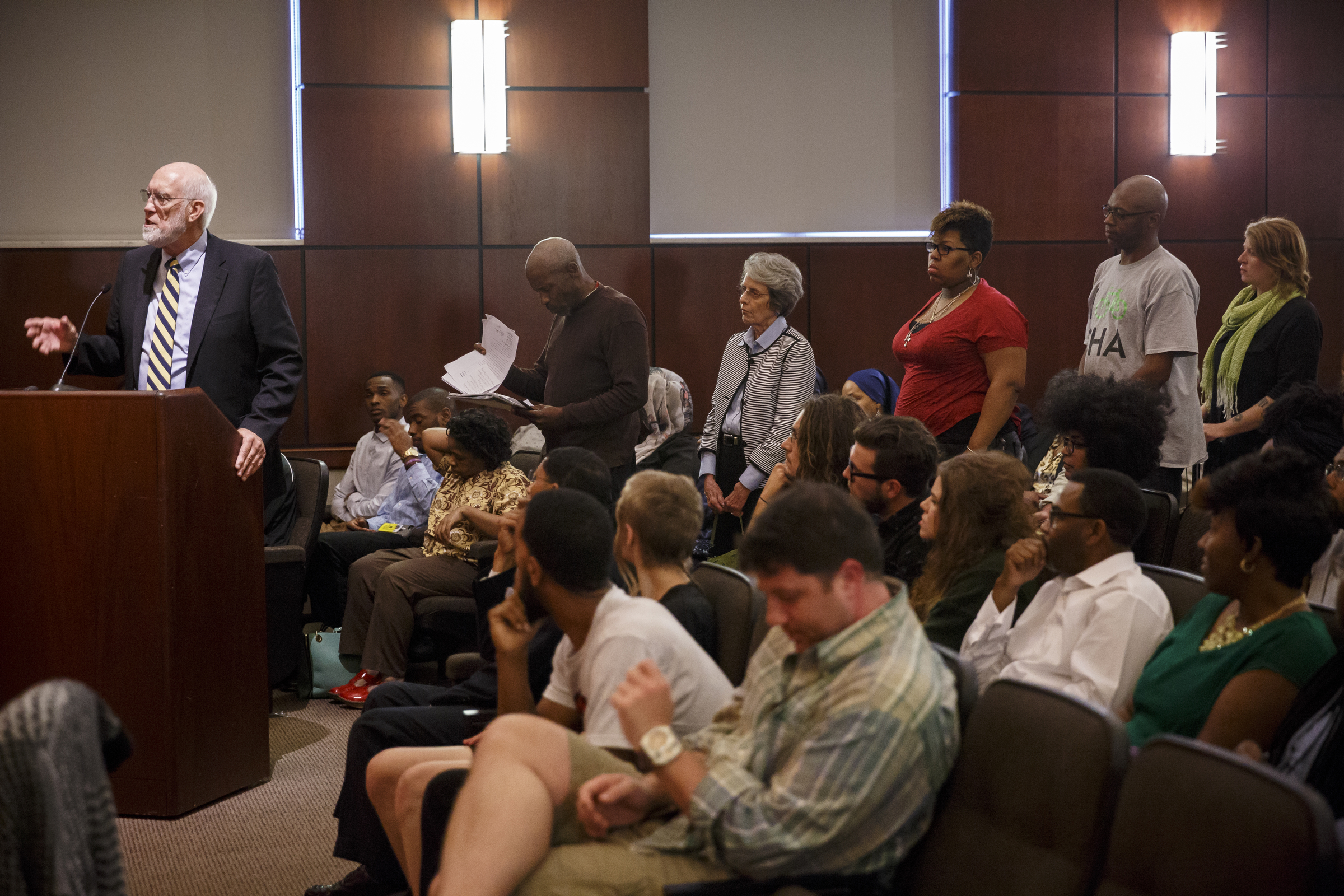 Community members line up behind Franklin McCallie to address the council during a Chattanooga City Council Meeting on Tuesday, May 3, 2016, in Chattanooga, Tenn. Kevin Muhammad, with the Nation of Islam, delivered what he called a