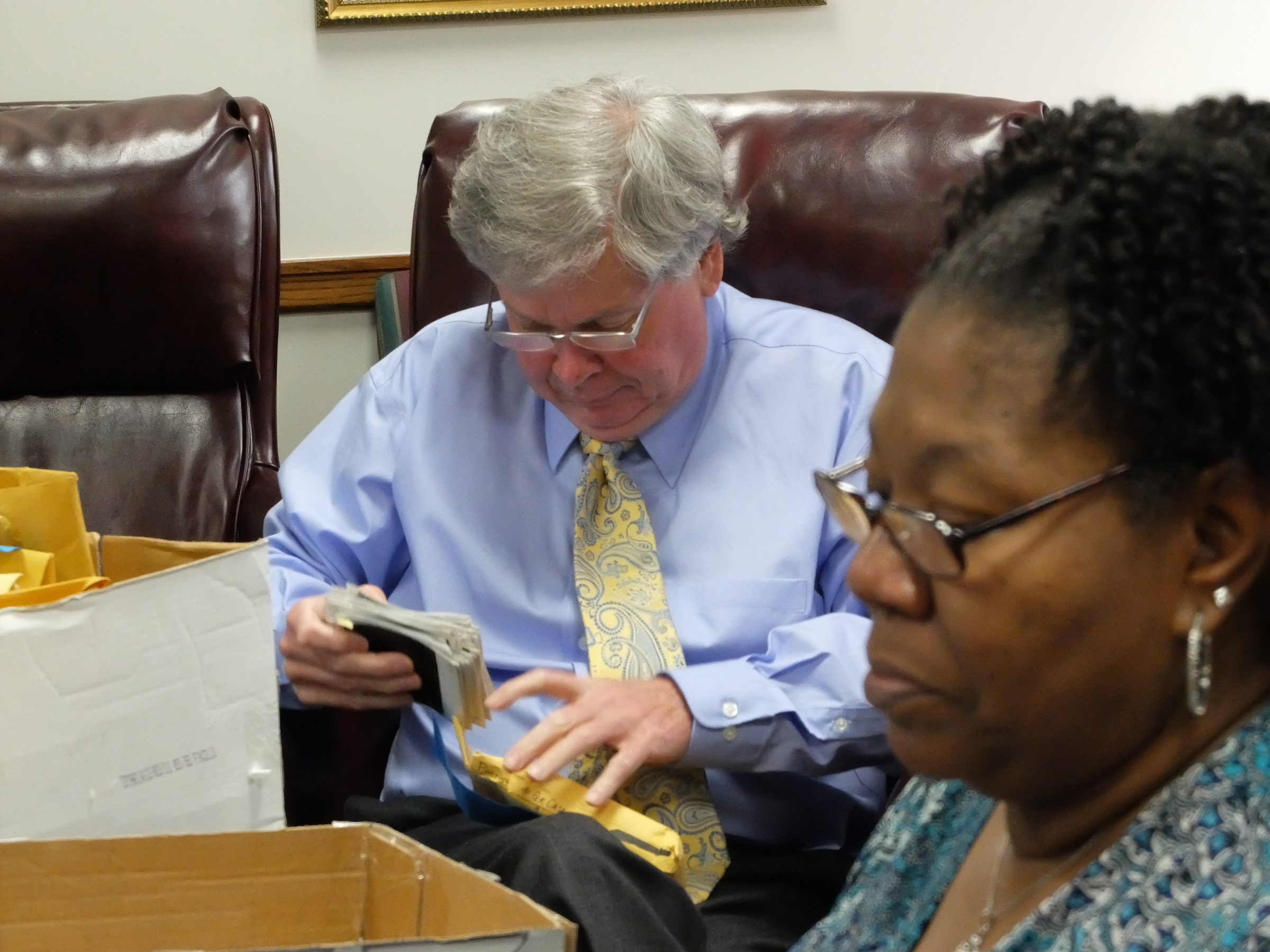 Hamilton County senior auditor Harry Mansfield, left, looks at evidence photos as audit clerk Johnetta Truss works looking at photographic negatives from cold cases.