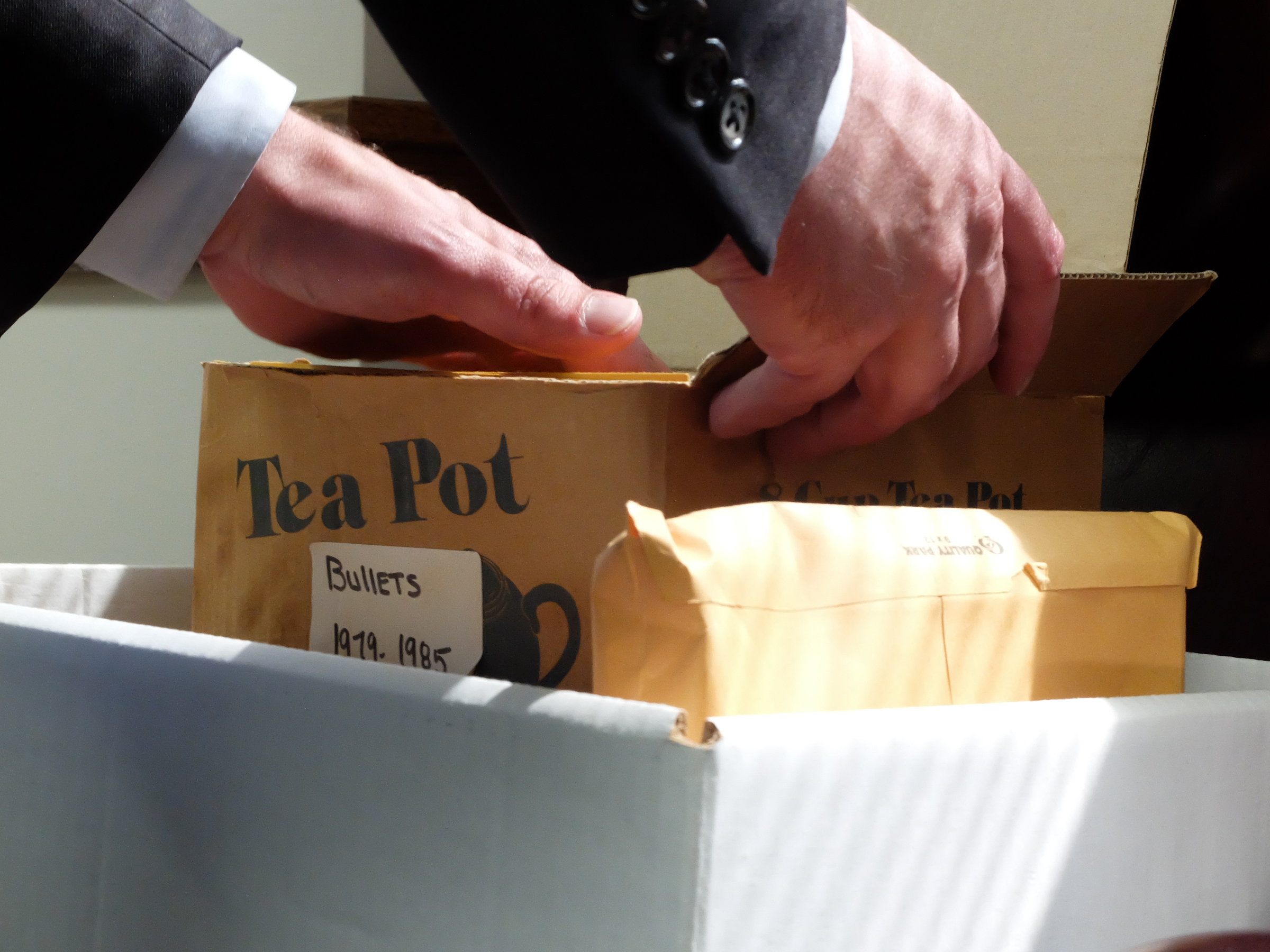 Attorney General Neal Pinkston looks through a box of bullets stored as evidence that were recently removed from the Medical Examiners office.