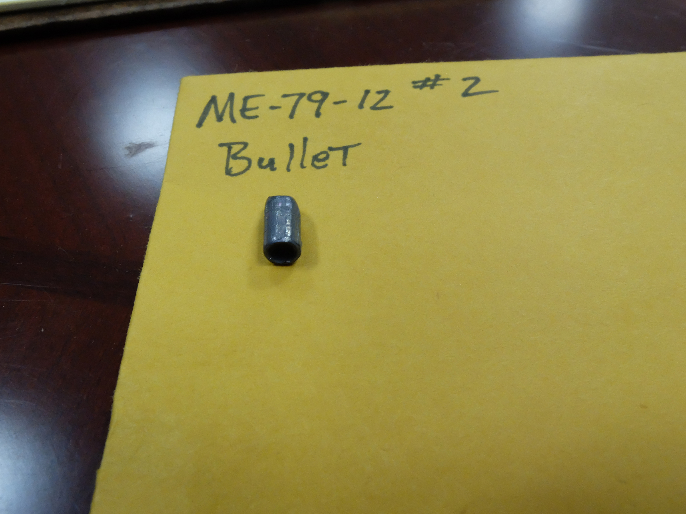 Attorney General Neal Pinkston pulled one bullet as evidence from a 1979 shooting. Most of the bullets are loose inside yellow envelopes.