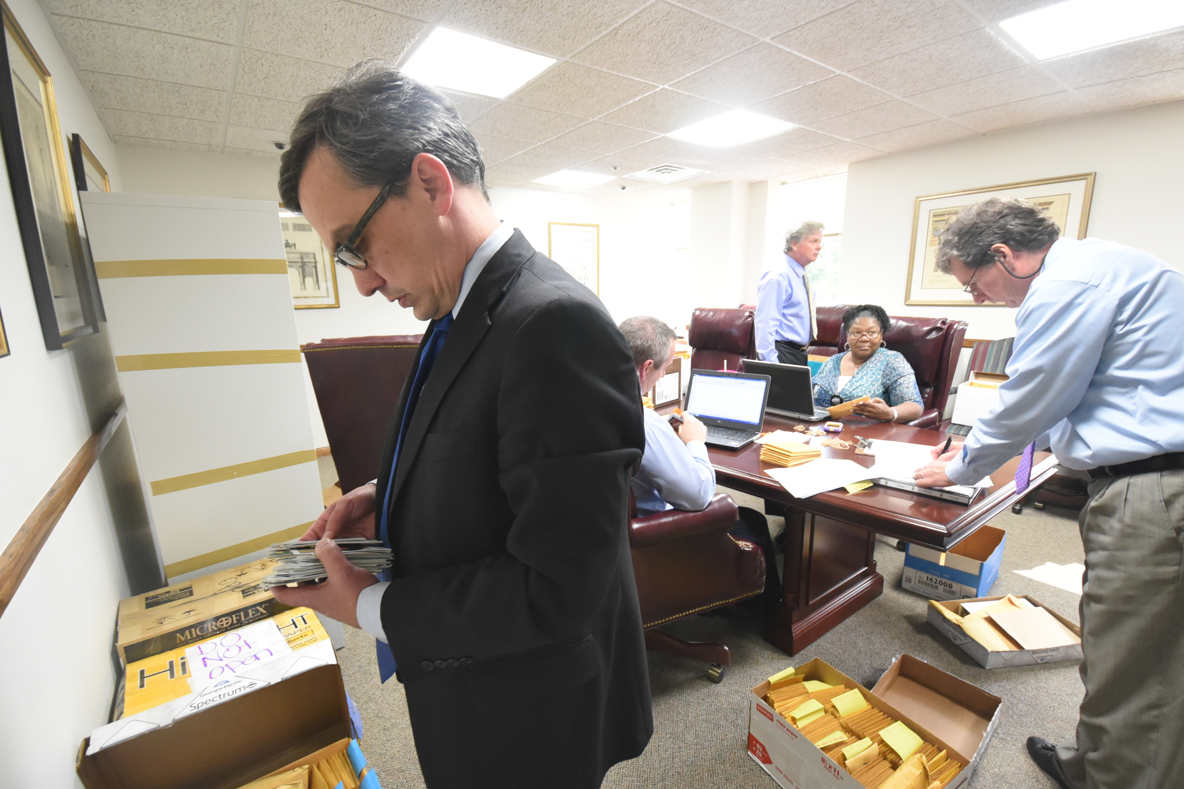 Attorney General Neal Pinkston, and a room full of Hamilton County auditors, go through thousands of evidence files recently removed from the Medical Examiners office.