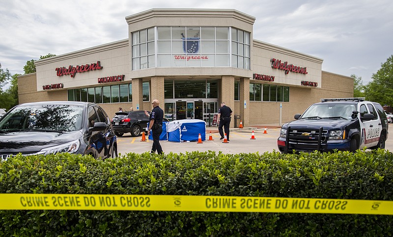 
              The body of a good samaritan lays under a blue tent after he was fatally shot outside a Walgreens on Monday, May 2, 2016, in Arlington, Texas, after he tried to stop a man who came to confront a woman who worked at the store. Arlington police say Anthony “T.J.” Antell Jr. saw Ricci Bradden shoot at the feet of his wife during an argument Monday outside of the Walgreens where she works, striking her once. Antell retrieved a handgun from his vehicle and confronted Bradden in an attempt to make a citizen’s arrest, but Bradden managed to slap it away and then fatally shot Antell, investigators say.  (Ashley Landis/The Dallas Morning News via AP)
            
