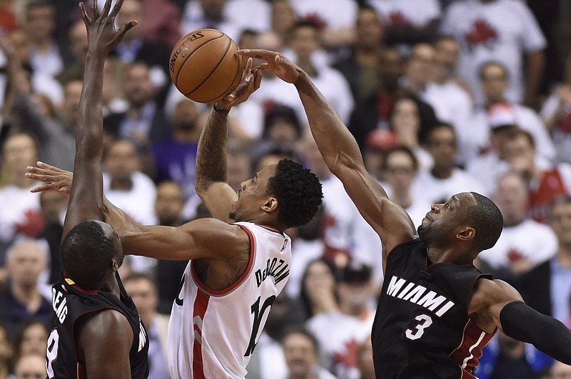 
              Miami Heat's Dwyane Wade (3) takes the ball from Toronto Raptors' DeMar DeRozan (10) during the second half in Game 1 of a second-round NBA basketball playoff series, Tuesday, May 3, 2016 in Toronto. (Frank Gunn/The Canadian Press via AP) MANDATORY CREDIT
            