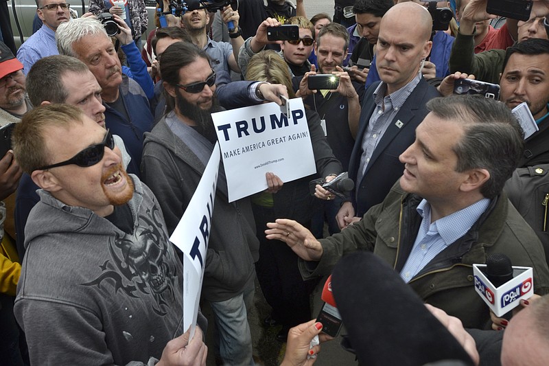 Republican presidential candidate Ted Cruz, right, exchanges words with Donald Trump supporters during a campaign visit to Marion, Ind., on Monday, May 2, 2016.