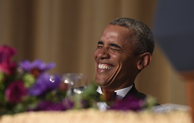 President Barack Obama laughs as he listens to Larry Wilmore, the guest host from Comedy Central, speak at the annual White House Correspondents' Association dinner at the Washington Hilton in Washington, Saturday, April 30, 2016.