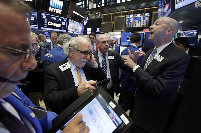 
              Specialist Jay Woods, right, works at the post that handles Intercontinental Exchange on the floor of the New York Stock Exchange, Wednesday, May 4, 2016. Intercontinental Exchange is jettisoning plans to acquire the London Stock Exchange and reported better-than-expected earnings for its first quarter, and said it would pay its dividend next month. (AP Photo/Richard Drew)
            