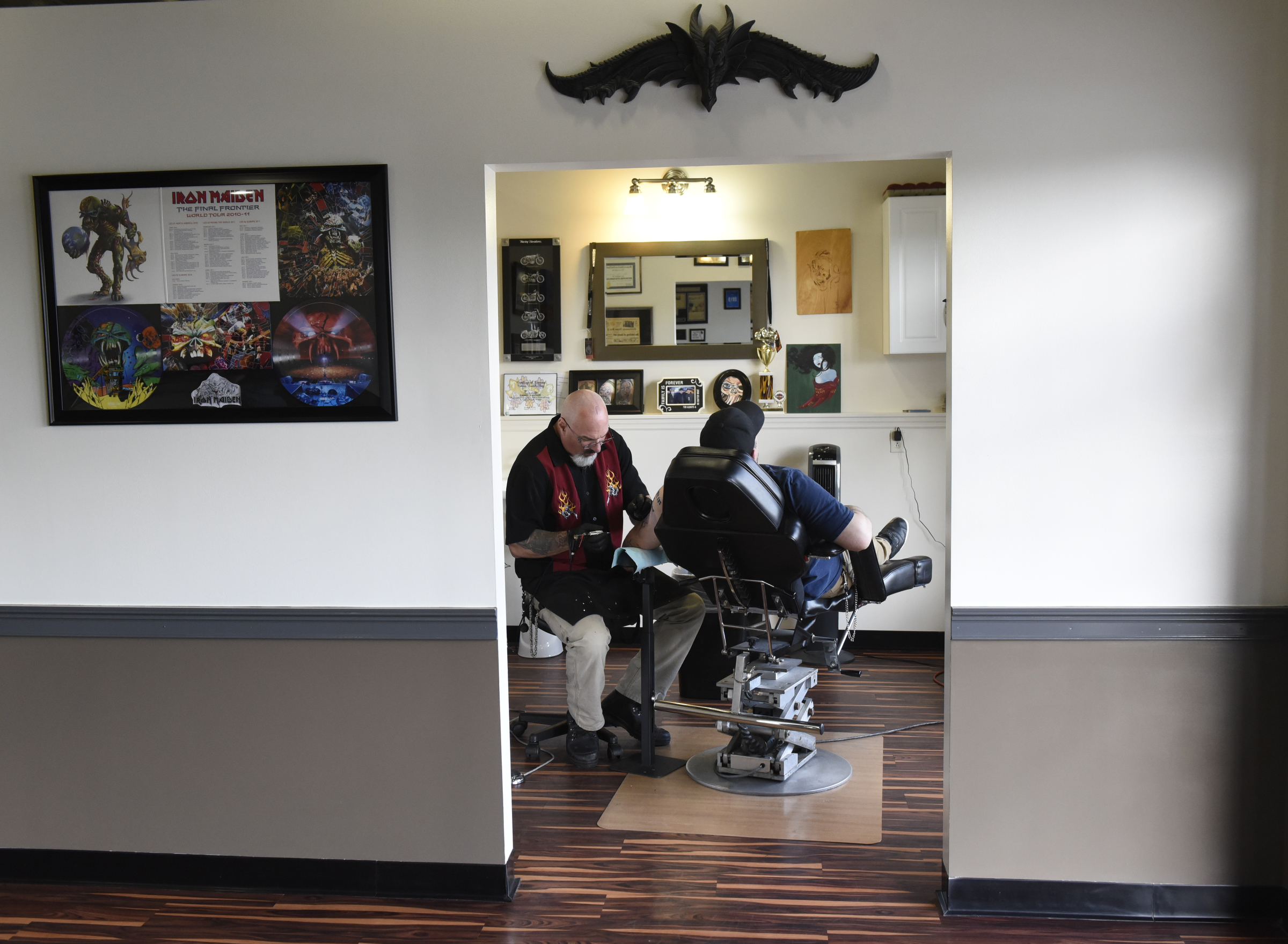 Daniel "Bones" LaLonde, owner of Freedom Tattoo, works to cover a previous tattoo on the arm of Craig Silvers on Tuesday, Apr. 26, 2016, in Chattanooga, Tenn.