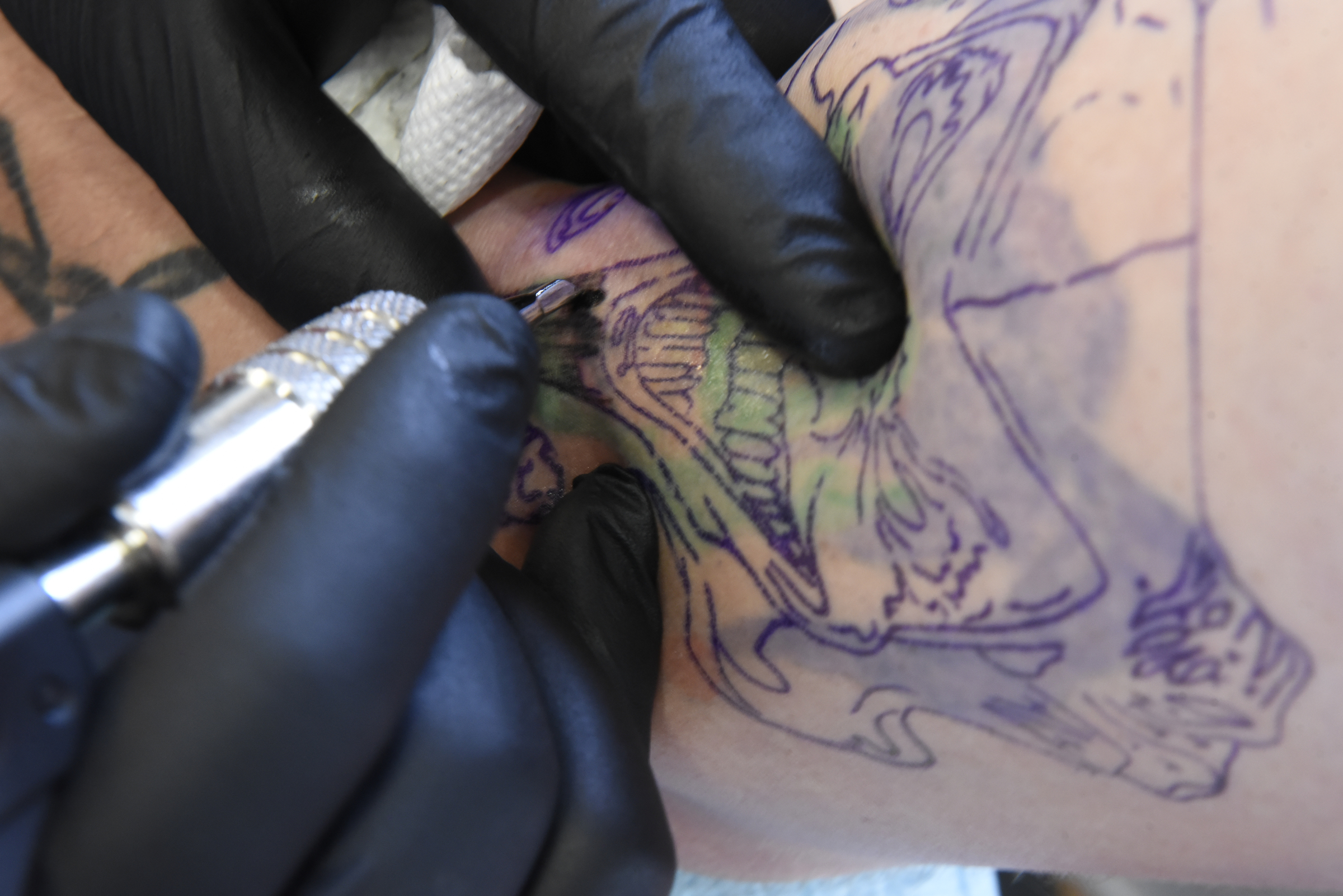 Daniel "Bones" LaLonde, owner of Freedom Tattoo, works to cover a previous tattoo on the arm of Craig Silvers on Tuesday, Apr. 26, 2016, in Chattanooga, Tenn.