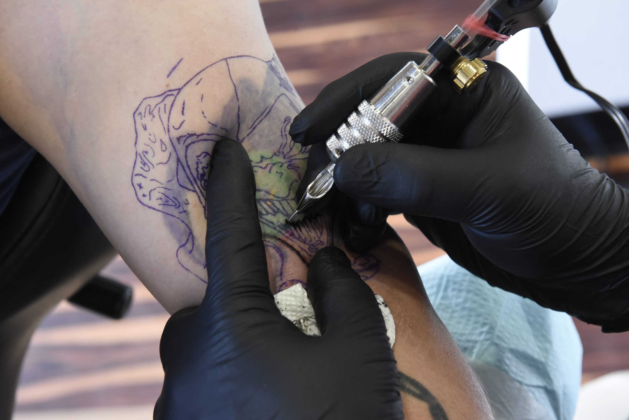 Daniel "Bones" LaLonde, owner of Freedom Tattoo, works to cover a previous tattoo on the arm of Craig Silvers on Tuesday, Apr. 26, 2016, in Chattanooga, Tenn.