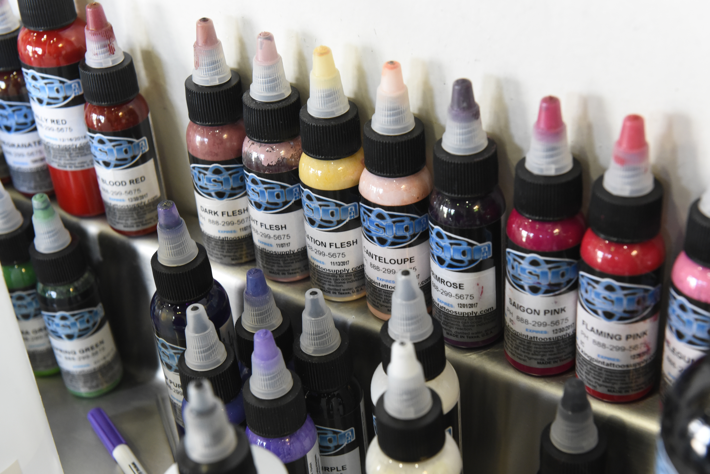 Multiple colors of ink are seen in the booth of tattoo and piercing artist Amanda Silvers at Freedom Tattoo on Tuesday, Apr. 26, 2016, in Chattanooga, Tenn.