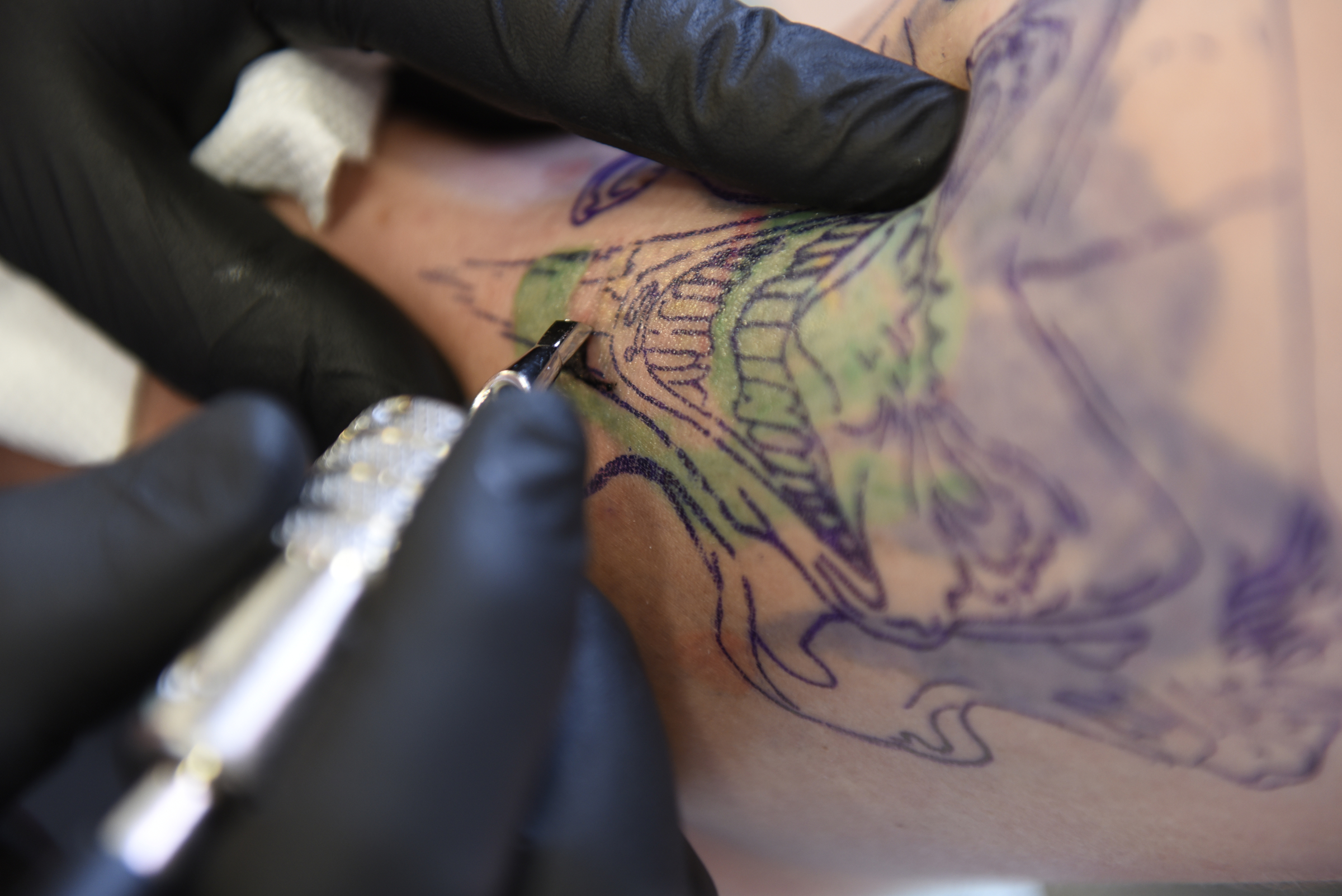 Daniel "Bones" LaLonde, owner of Freedom Tattoo, works to cover a previous tattoo on the arm of Craig Silvers on Tuesday, Apr. 26, 2016, in Chattanooga, Tenn.