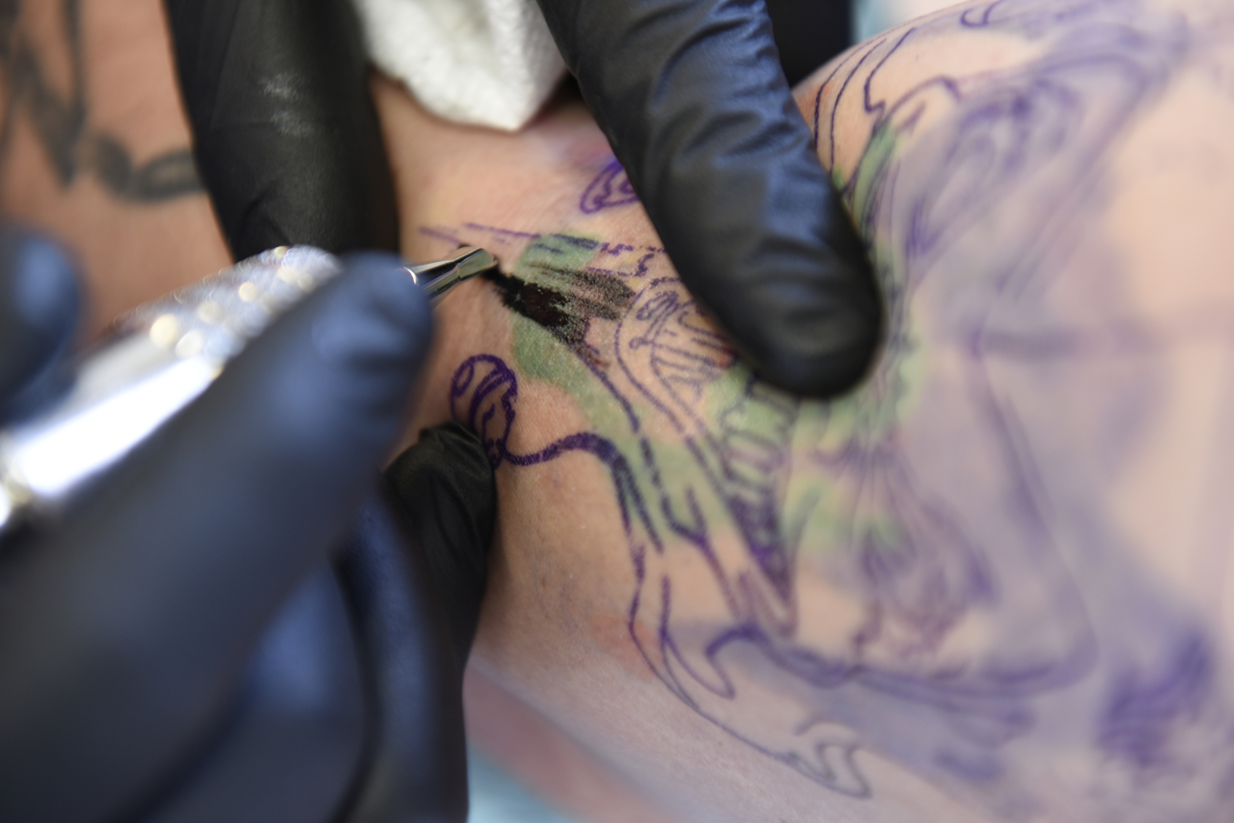 Daniel "Bones" LaLonde, owner of Freedom Tattoo, works to cover a previous tattoo on the arm of Craig Silvers on Tuesday, Apr. 26, 2016, in Chattanooga, Tenn.