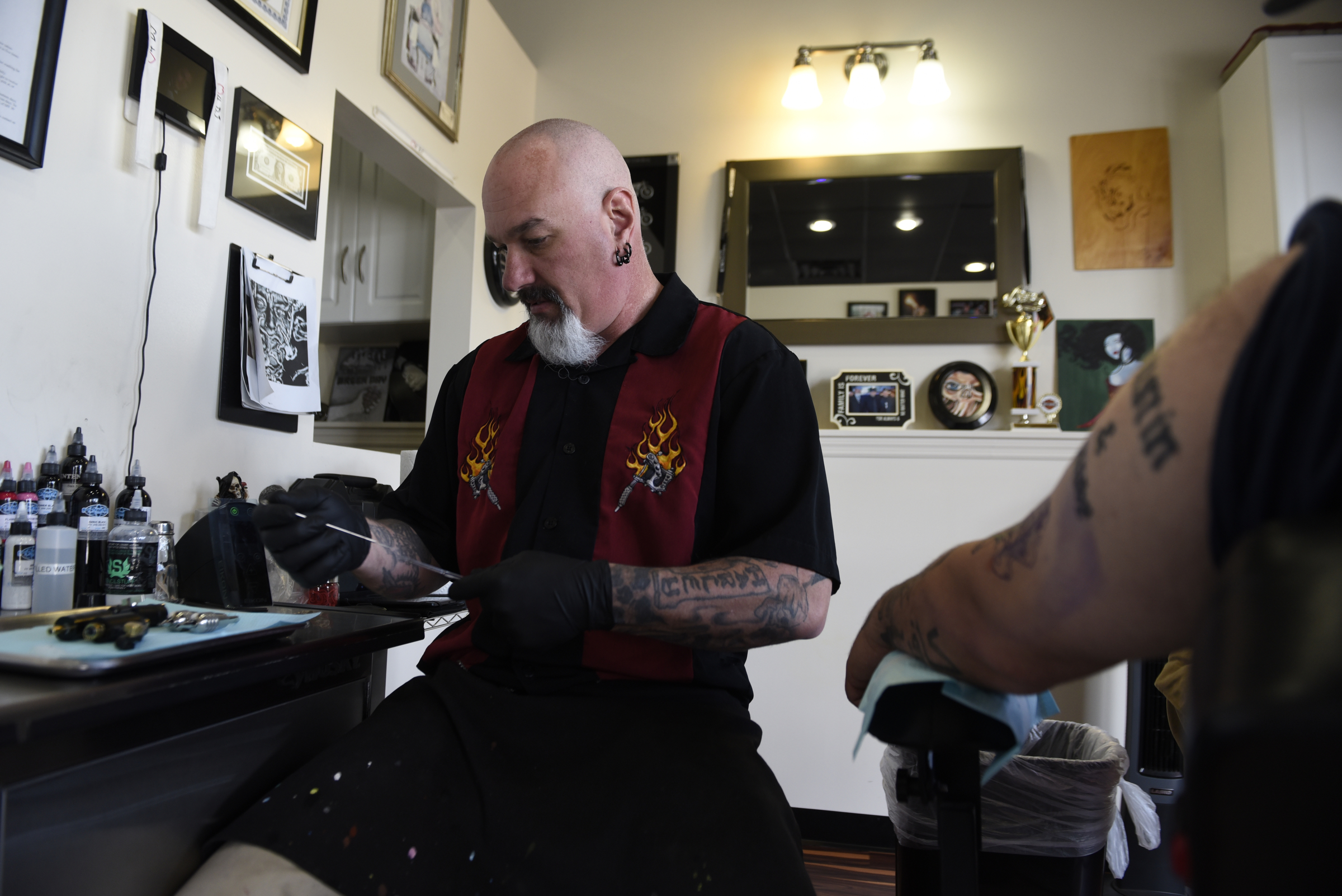 Daniel "Bones" LaLonde, owner of Freedom Tattoo, prepares his tools to cover a previous tattoo on the arm of Craig Silvers on Tuesday, Apr. 26, 2016, in Chattanooga, Tenn.
T