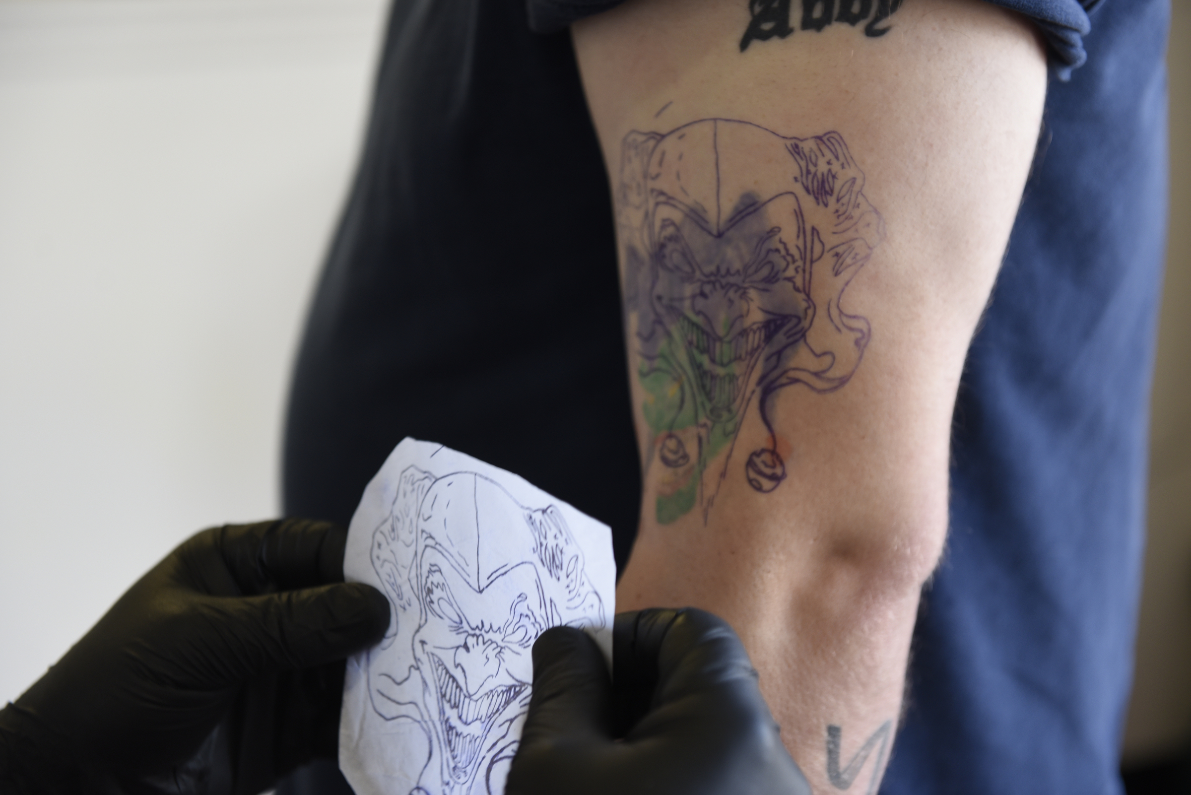 Daniel "Bones" LaLonde, owner of Freedom Tattoo, figures out where to place the stencil as he works to cover a previous tattoo on the arm of Craig Silvers on Tuesday, Apr. 26, 2016, in Chattanooga, Tenn.