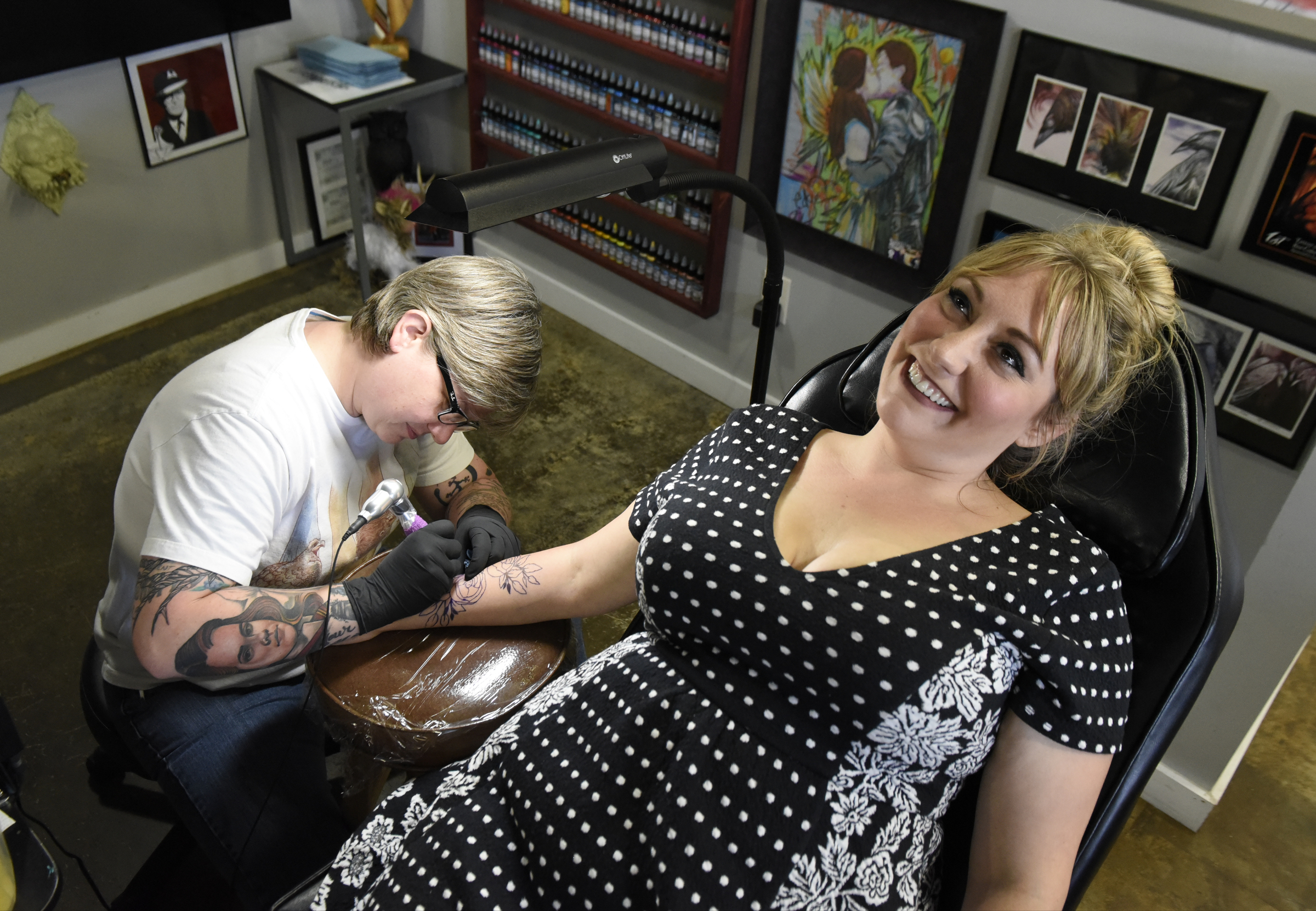 Jennifer Edge of Main Line Ink, left, puts a tattoo on the forearm of Linsey Martin, who drove four hours from Amory, Miss., on Thursday, Apr. 28, 2016, in Chattanooga, Tenn.