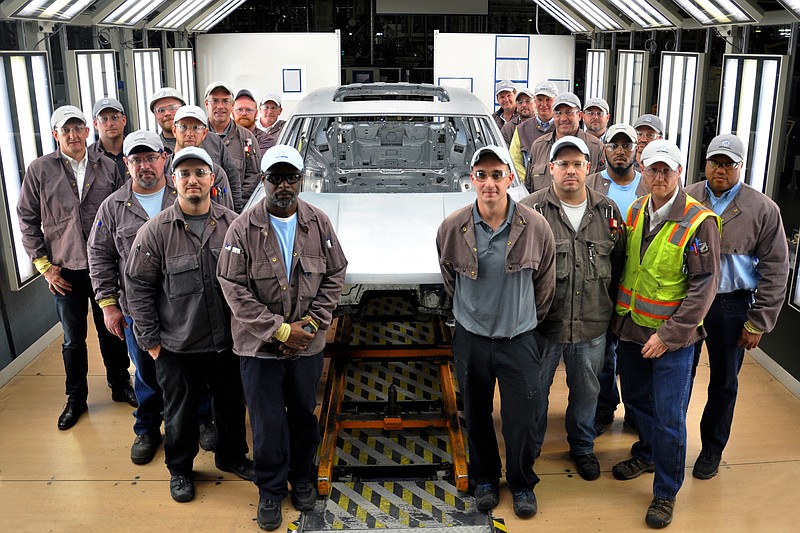 Workers at Volkswagen's Chattanooga plant surround the first assembled metal test body for the upcoming midsize sport utility vehicle.