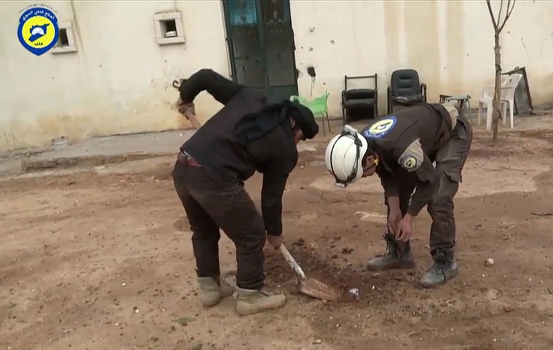 
              In this still image made from video taken Jan. 31, 2016 provided by the Civil Defence Force in Aleppo, Syrian volunteers dig an unexploded ordnance out of the ground in Hayan, Aleppo. Volunteer sappers in opposition-held areas of Syria are improvising their approaches to one of the world's most dangerous tasks: dismantling cluster munitions, land mines and explosive booby-traps as they work to make battle-torn areas safe for civilians to return. The result has been tragic. (Civil Defence Force in Aleppo via AP)
            