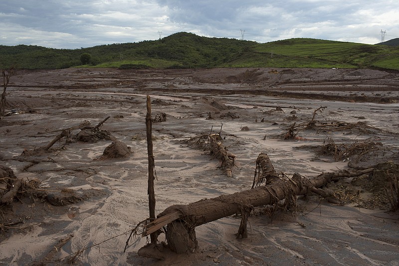 
              FILE - This is  Nov. 23, 2015  file photo of debris awash in mud in Bento Rodrigues, Brazil. After obliterating several towns, the tide of mud and debris surged forward, blanketing a wide swath of land and cascading into the Doce River.  Shares in miner BHP Billiton Ltd tumbled Wednesday May 4, 2016  after Brazil's Federal Public Prosecution said it had launched a $43 billion civil suit for a dam break that killed 19 people and caused the worst environmental disaster in the country's history.(AP Photo/Leo Correa, File)
            