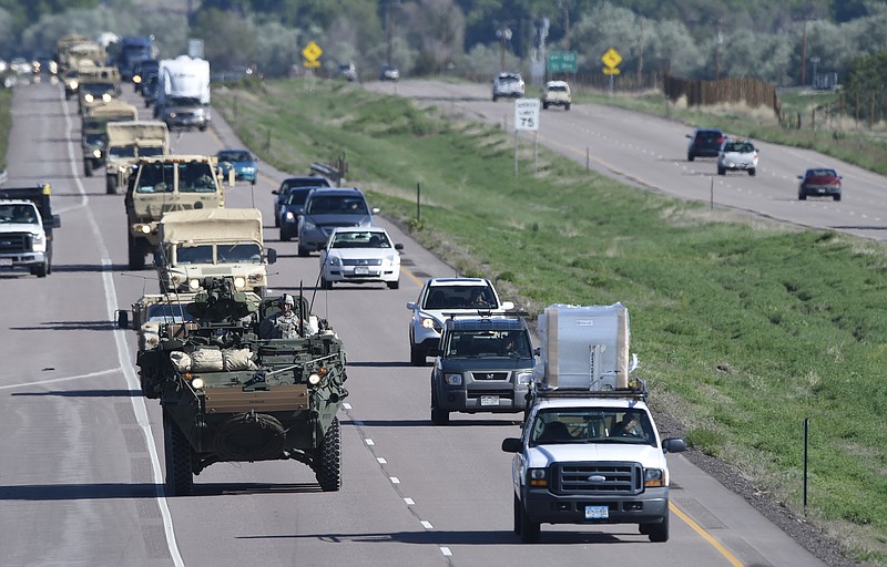 
              FILE - In this May 27, 2015 file photo, a Stryker armored vehicle leads a group of vehicles south on I-25 south in Colorado Springs, Colo. Investigators say an Army vehicle took the wrong road in the dark and was trying to make a U-turn when it tumbled 250 feet off a cliff at a Colorado training range in Feb. 2015, killing one soldier and injuring five. Investigators also said medical personnel had recommended that the soldier who died shouldn’t go on the exercise because of an unspecified condition. But it wasn’t clear if his condition was a factor in the 2015 crash of a Stryker fighting vehicle at Fort Carson. (Mark Reis/The Gazette via AP, File) MAGS OUT; MANDATORY CREDIT
            