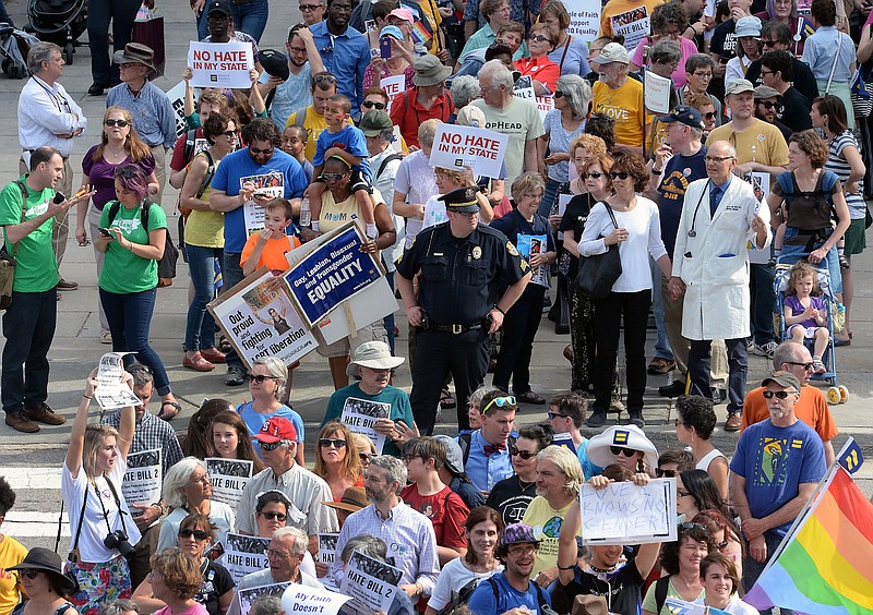 Protesters head into the Legislative building for a sit-in against House Bill 2 in Raleigh, N.C., Monday, April 25, 2016. While demonstrations circled North Carolina's statehouse on Monday, for and against a Republican-backed law curtailing protections for LGBT people and limiting public bathroom access for transgender people, House Democrats filed a repeal bill that stands little chance of passing. 