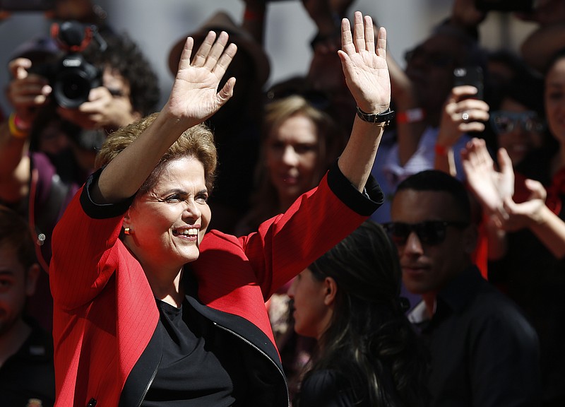 
              Brazil's President Dilma Rousseff gestures to supporters during a May Day rally in Sao Paulo, Brazil, Sunday, May 1, 2016. President Rousseff is facing impeachment over allegations her administration violated fiscal laws. (AP Photo/Andre Penner)
            