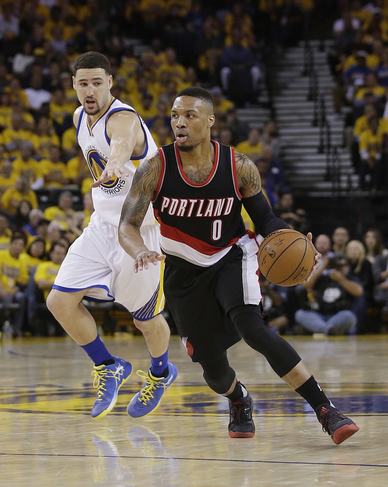 
              Portland Trail Blazers' Damian Lillard (0) dribbles past Golden State Warriors' Klay Thompson during the first half in Game 2 of a second-round NBA basketball playoff series Tuesday, May 3, 2016, in Oakland, Calif. (AP Photo/Marcio Jose Sanchez)
            