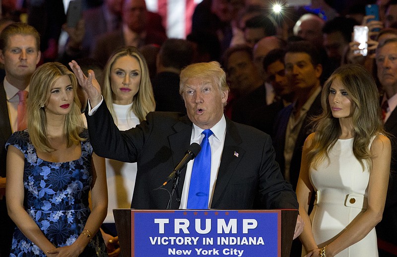 Republican presidential candidate Donald Trump is joined by his wife Melania, right, daughter Ivanka, left, and son Eric, background left, as he speaks during a primary night news conference, Tuesday, May 3, 2016, in New York.