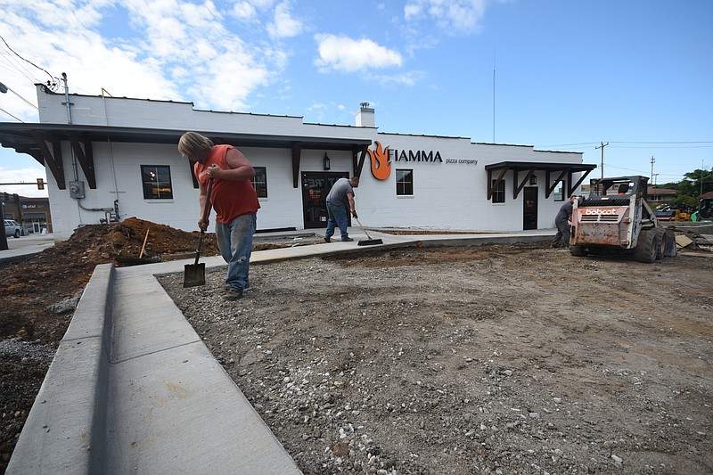 Young's Paving employee's Jerry Cox, left, and Nick Titus work the parking area in front of Fiamma Pizza Restaurant on North Market Street.