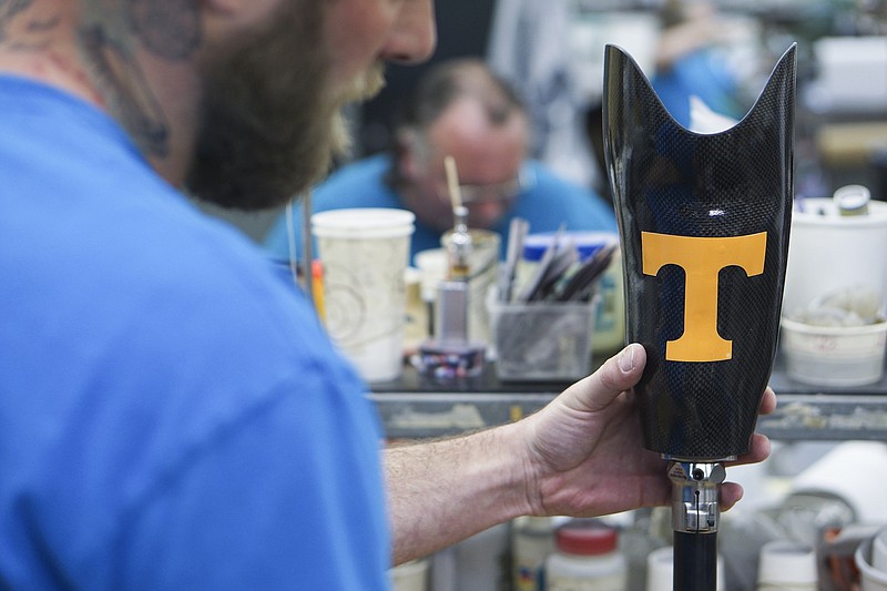 A prosthetic technician at a Fillauer facility in Chattanooga assembles a below-the-knee limb system.