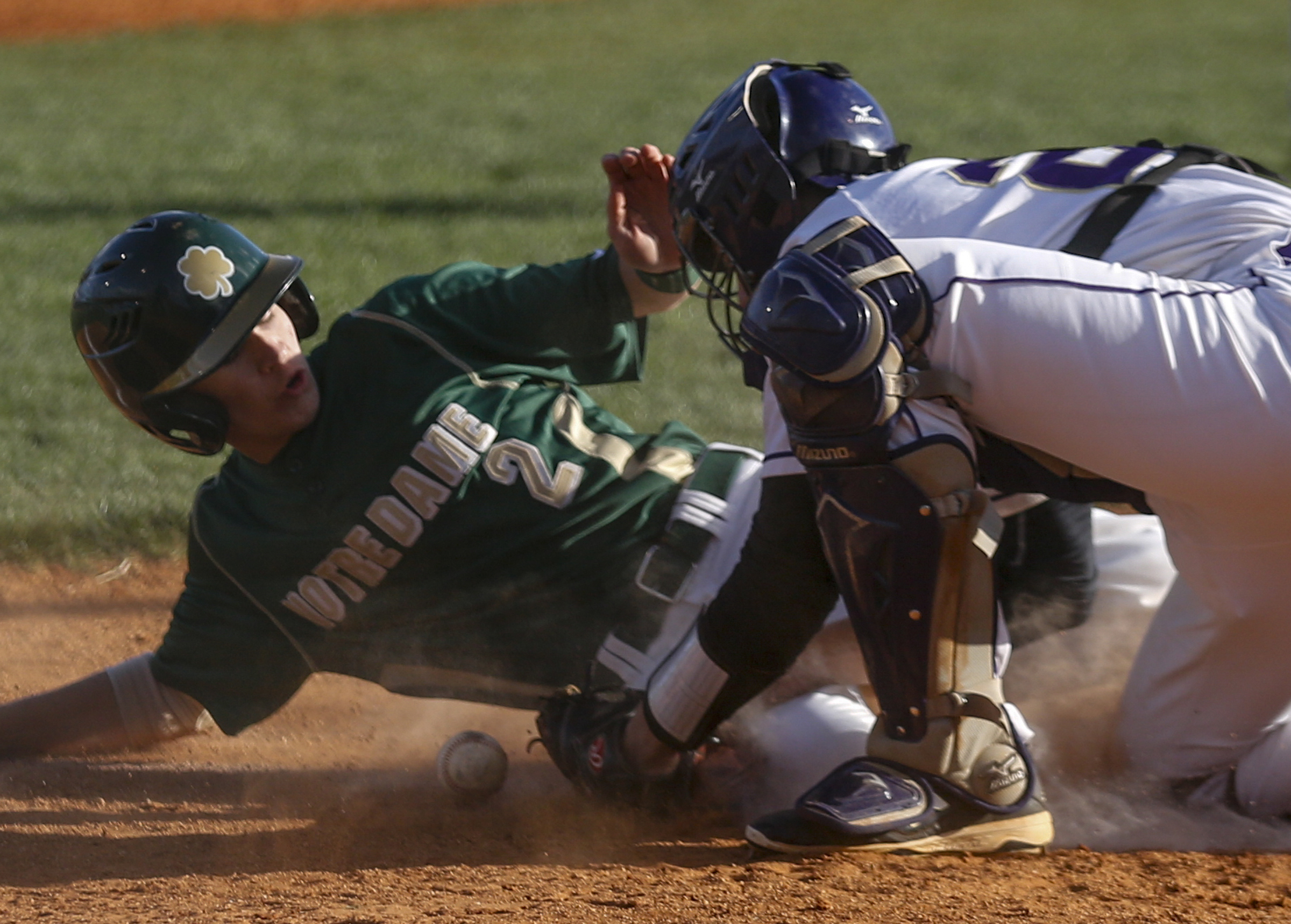 Notre Dame runner Aiden Krehl is safe at home as the Sequatchie County catcher Braden Lawson tries to pick up the ball during their District 7-AA baseball tournament play-in game at Sequatchie County High School on Thursday, May 5, 2016, in Dunlap, Tenn.