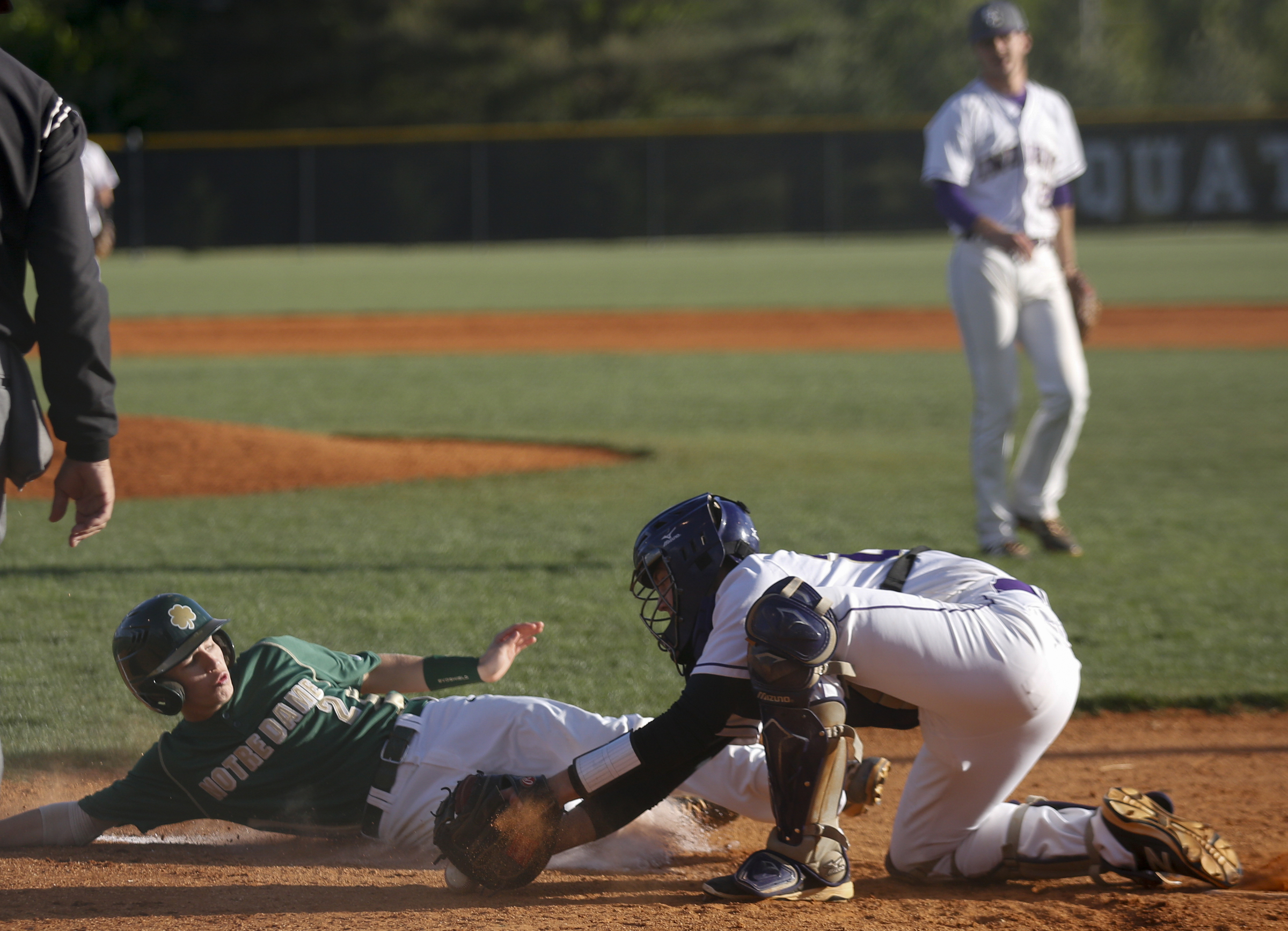 Notre Dame runner Aiden Krehl is safe at home as the Sequatchie County catcher Braden Lawson tries to pick up the ball during their District 7-AA baseball tournament play-in game at Sequatchie County High School on Thursday, May 5, 2016, in Dunlap, Tenn.
