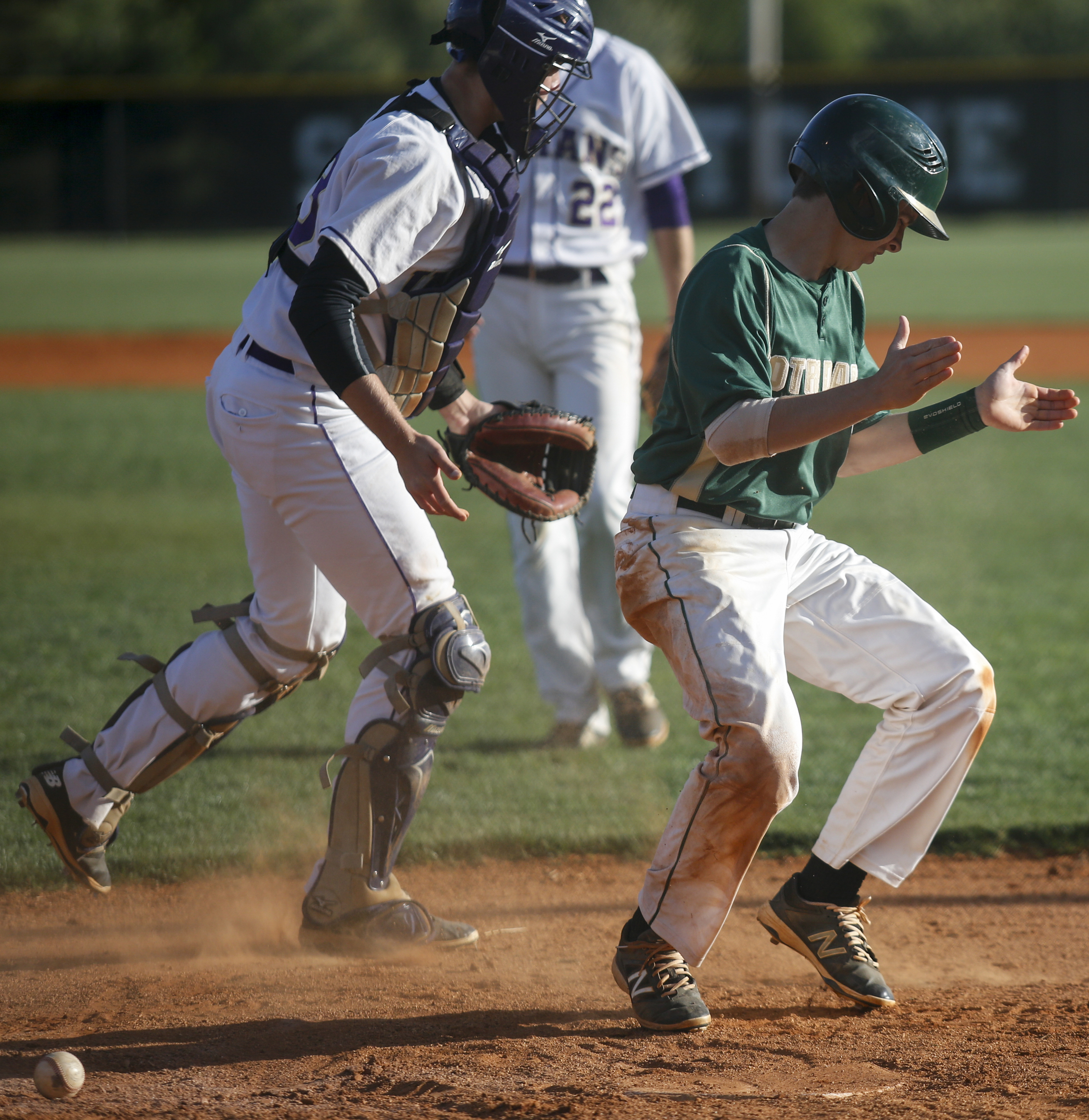 Notre Dame runner Aiden Krehl claps after scoring a run as the Sequatchie County catcher Braden Lawson tries to find the ball during their District 7-AA baseball tournament play-in game at Sequatchie County High School on Thursday, May 5, 2016, in Dunlap, Tenn.