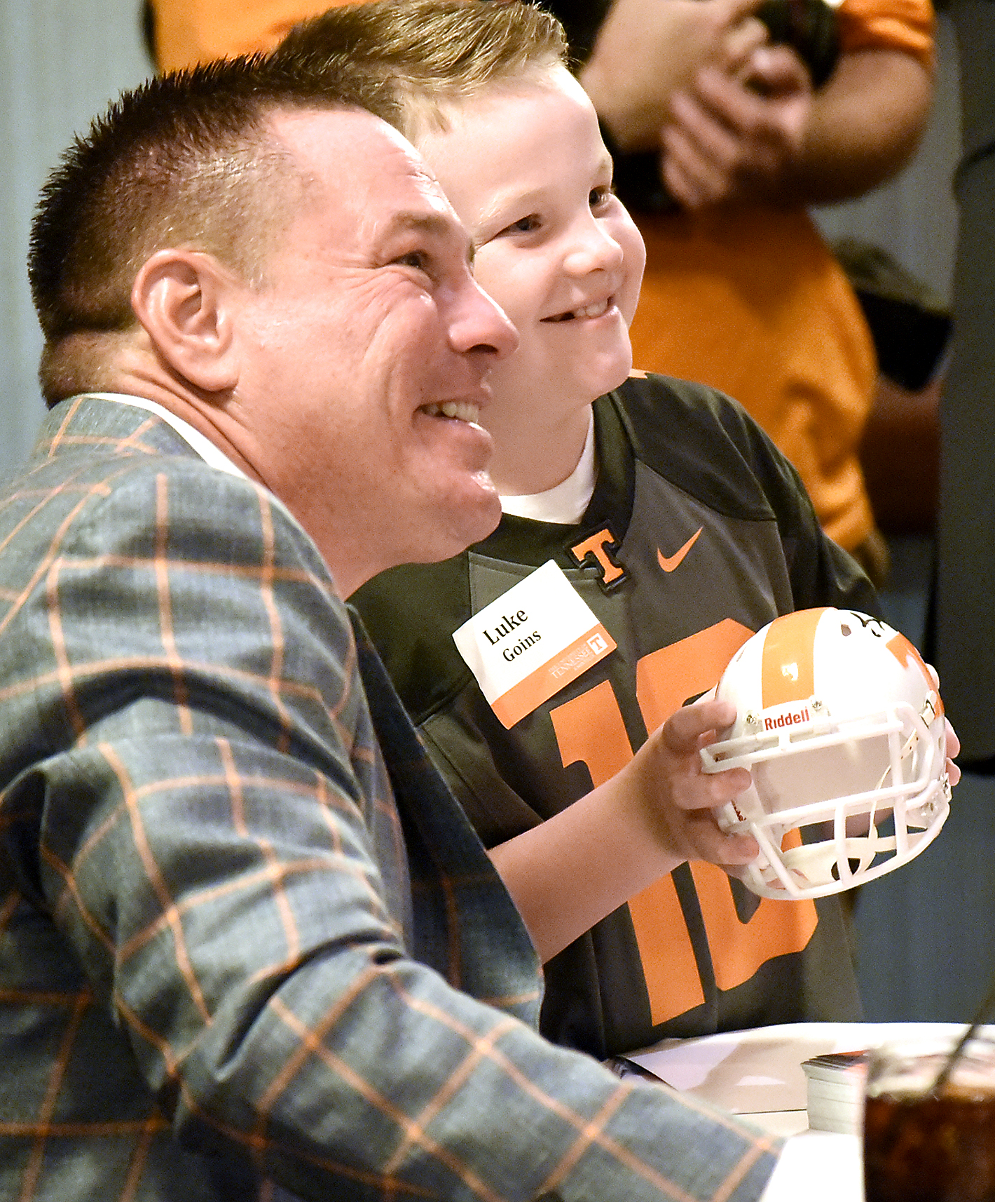 Luke Goins holds his autographed helmut as he has his photo made with UT head football coach Butch Jones.  The University of Tennessee Big Orange Caravan rolled into town at the Chattanoogan on Thursday May 5, 2016.