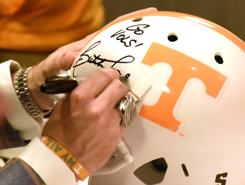 UT head football coach Butch Jones signs a helmet. The University of Tennessee Big Orange Caravan rolled into town at the Chattanoogan on Thursday May 5, 2016.