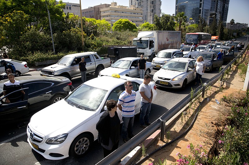 
              Israelis stand still next to their cars as a siren sounds in memory of victims of the Holocaust in Tel Aviv, Israel, Thursday, May 5, 2016. Israel is marking its annual Holocaust remembrance day in memory of the 6 million Jews killed by Nazi Germany and its collaborators. (AP Photo/Sebastian Scheiner)
            