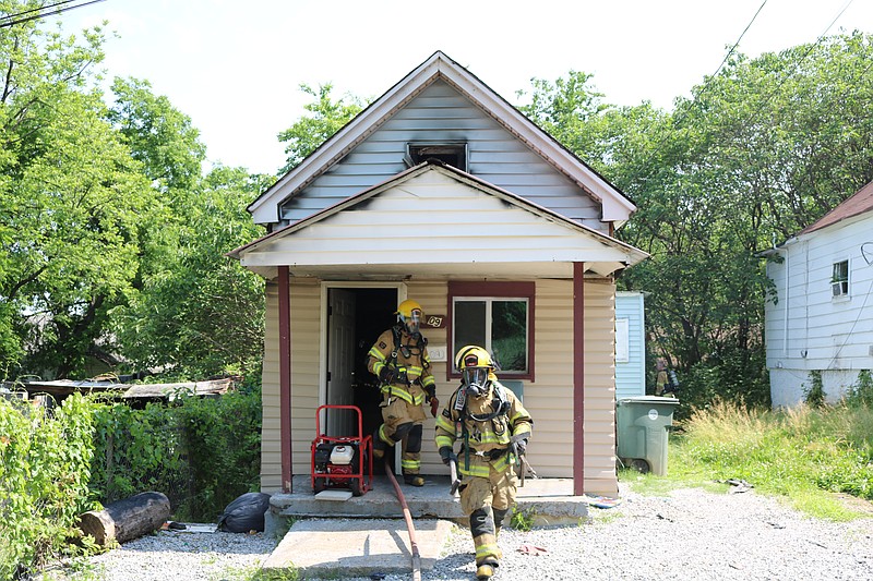 Firefighters extinguish a house fire at 2609 Reece Street in Chattanooga on Friday, May 6.