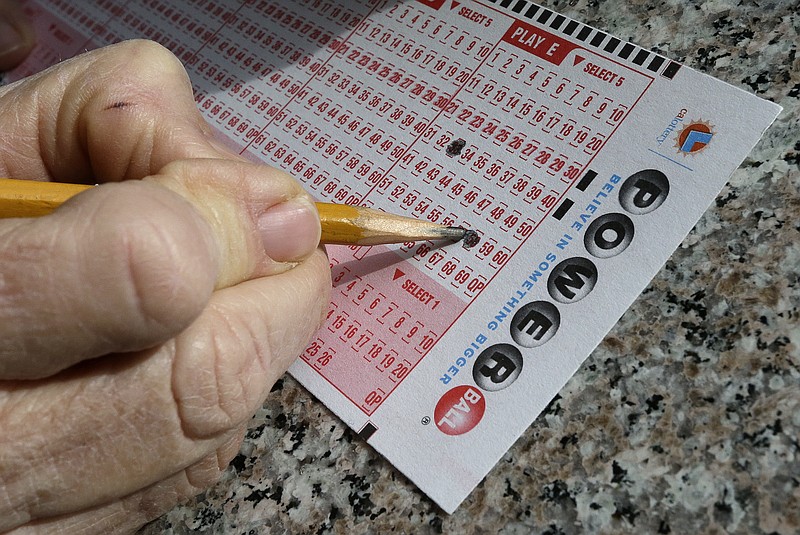 
              FILE - In this Jan. 12, 2016 file photo, a lottery player fills out numbers on a powerball form in Oakland, Calif. The Powerball jackpot has grown to over 1.5 billion dollars. Only ne ticket matched all six numbers in the drawing Saturday, May 7, for a $429.6 million jackpot, said Powerball spokeswoman Kelly Cripe, and New Jersey lottery officials said Sunday it was sold at a 7-Eleven store in Trenton, N.J. (AP Photo/Ben Margot, File)
            