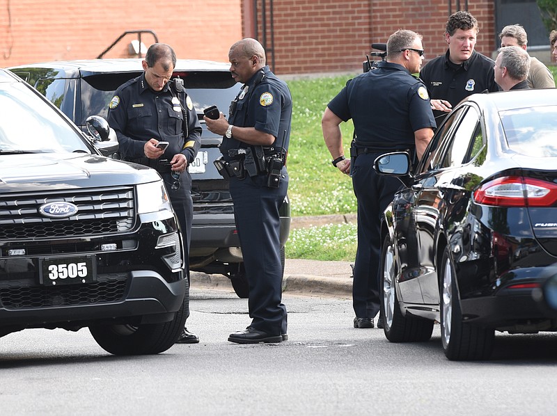 Chattanooga Police Chief Fred Fletcher, left, helps work the scene of a shooting on Jeffery Lane late Tuesday. The victim, Orlando Gay, 26, was shot multiple times. He was taken to Erlanger hospital where he later died from his injuries.