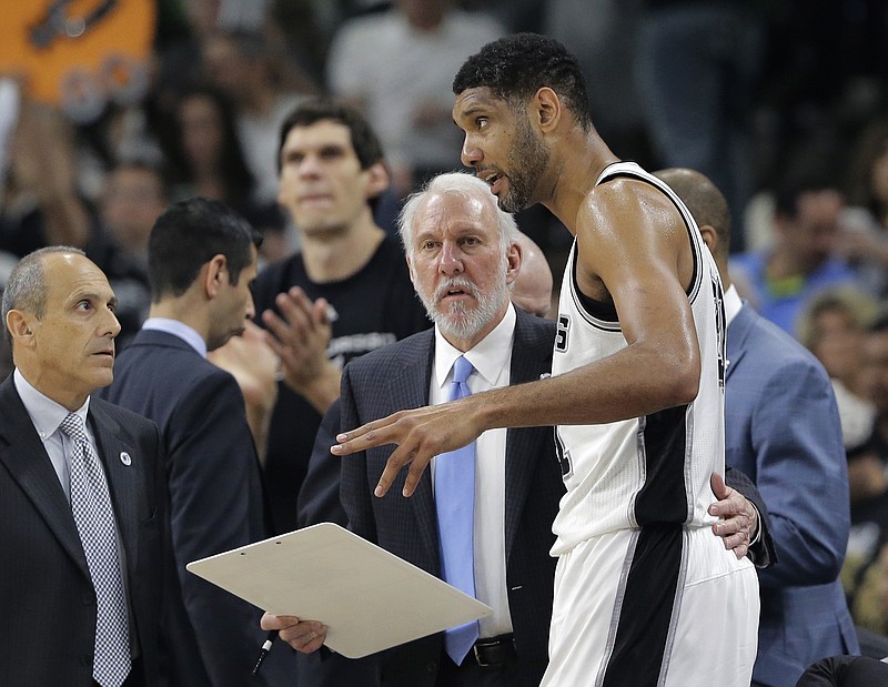San Antonio Spurs coach Gregg Popovich, center, talks with veteran forward Tim Duncan, right, during Tuesday night's playoff game against Oklahoma City in San Antonio. The Thunder won 95-91.