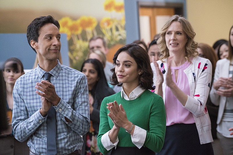 
              This photo provided by NBC shows, Danny Pudi, from left, as Teddy, Vanessa Hudgens as Emily, and Christina Kirk as Jackie in the NBC television pilot for "Powerless."  A comedy series starring Hudgens and set in the DC Comics world is coming to NBC. The network said Wednesday, May 11, 2016, it's ordered "Powerless" for the 2016-17 season. (Chris Large/NBC via AP)
            