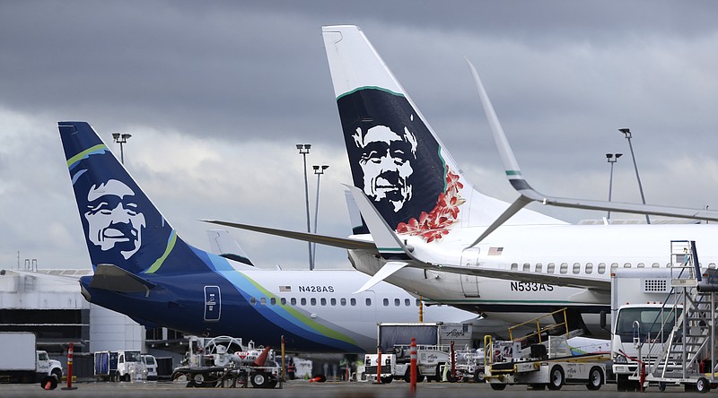 
              FILE - In this Monday, April 4, 2016, file photo, Alaska Airlines planes with the company's new livery and tail logo, left, and the old livery used to promote service to Hawaii, right, are shown parked at Seattle-Tacoma International Airport in Seattle. Alaska Airlines and JetBlue Airways still rank highest in the annual J.D. Power survey of passengers on the nine largest North American airlines, and the firm says overall traveler satisfaction with the industry is at a 10-year high. J.D. Power said Wednesday, May 11, 2016, that Alaska ranked highest among traditional airlines for the ninth straight year and JetBlue was the top-rated low-cost carrier for the 11th year in a row. (AP Photo/Ted S. Warren, File)
            