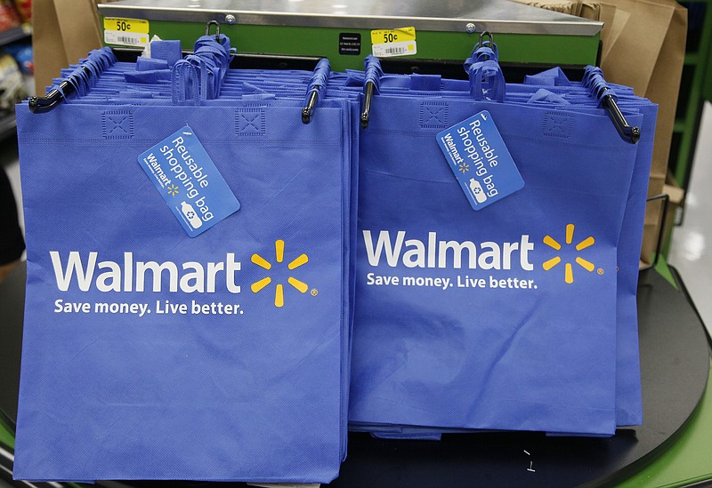 
              FILE - In this Thursday, Sept. 19, 2013, file photo, reusable shopping bags are offered for sale at a Wal-Mart Neighborhood Market, in the Chinatown district of Los Angeles. Wal-Mart is sharpening its attack against Amazon. The discounter says it is changing its membership-based free shipping service test to two days from three days and is charging one dollar less for the annual membership fee. Wal-Mart began testing the service in 2015 as a way to counter Amazon’s highly successful Prime shipping. (AP Photo/Nick Ut, File)
            