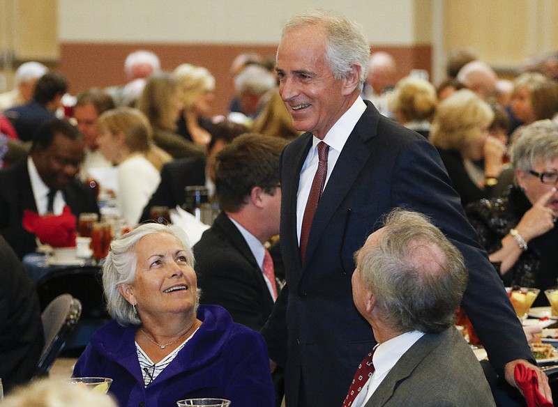 Sen. Bob Corker, R-Tenn., standing, speaks to Janet and Bill Horton during the Chattanooga History Center's annual luncheon in November.