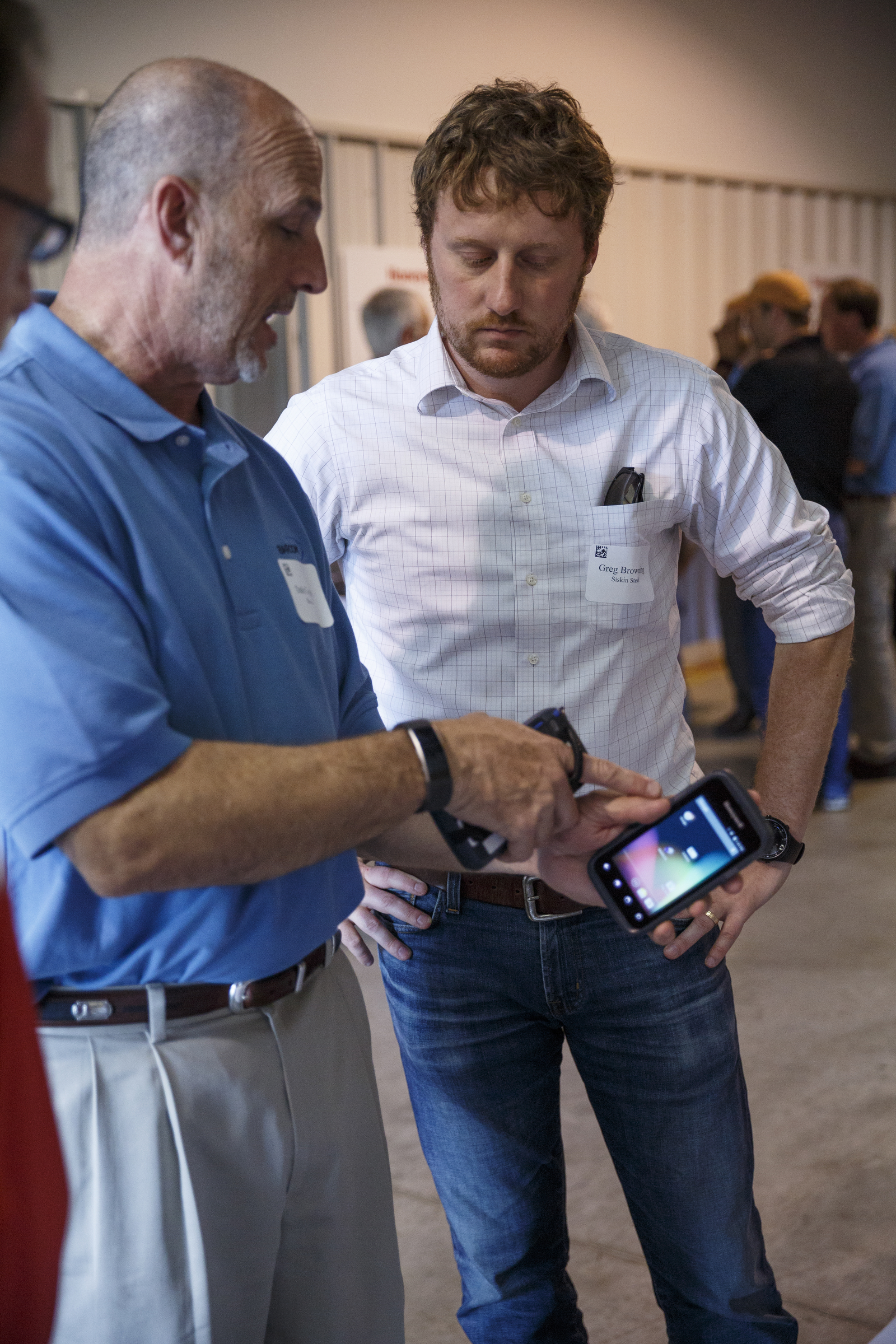 Dale Conerly, left, talks to Greg Browning about a barcode scanner during an open house at the company Barcom on Thursday, May 12, 2016, in Chattanooga, Tenn. The business, which makes equipment for managing and scanning bar codes, is celebrating its 25th year.